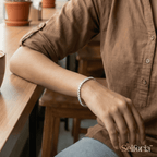 Woman wearing a silver stone tennis bracelet styled for office wear and casual looks