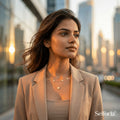 Woman wearing a gold plated layered necklace paired with a modern office blazer