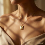 Woman wearing gold love letter pendant necklace for an evening look