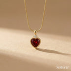 Close-up of red heart pendant necklace with gold finish