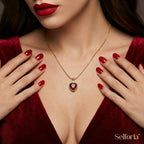 Woman wearing gold-plated red heart necklace with elegant outfit