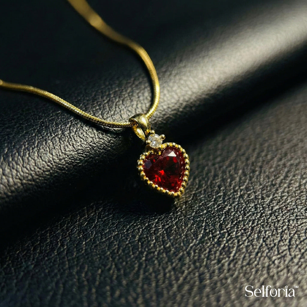 Macro shot of red heart pendant necklace showing stone detailing