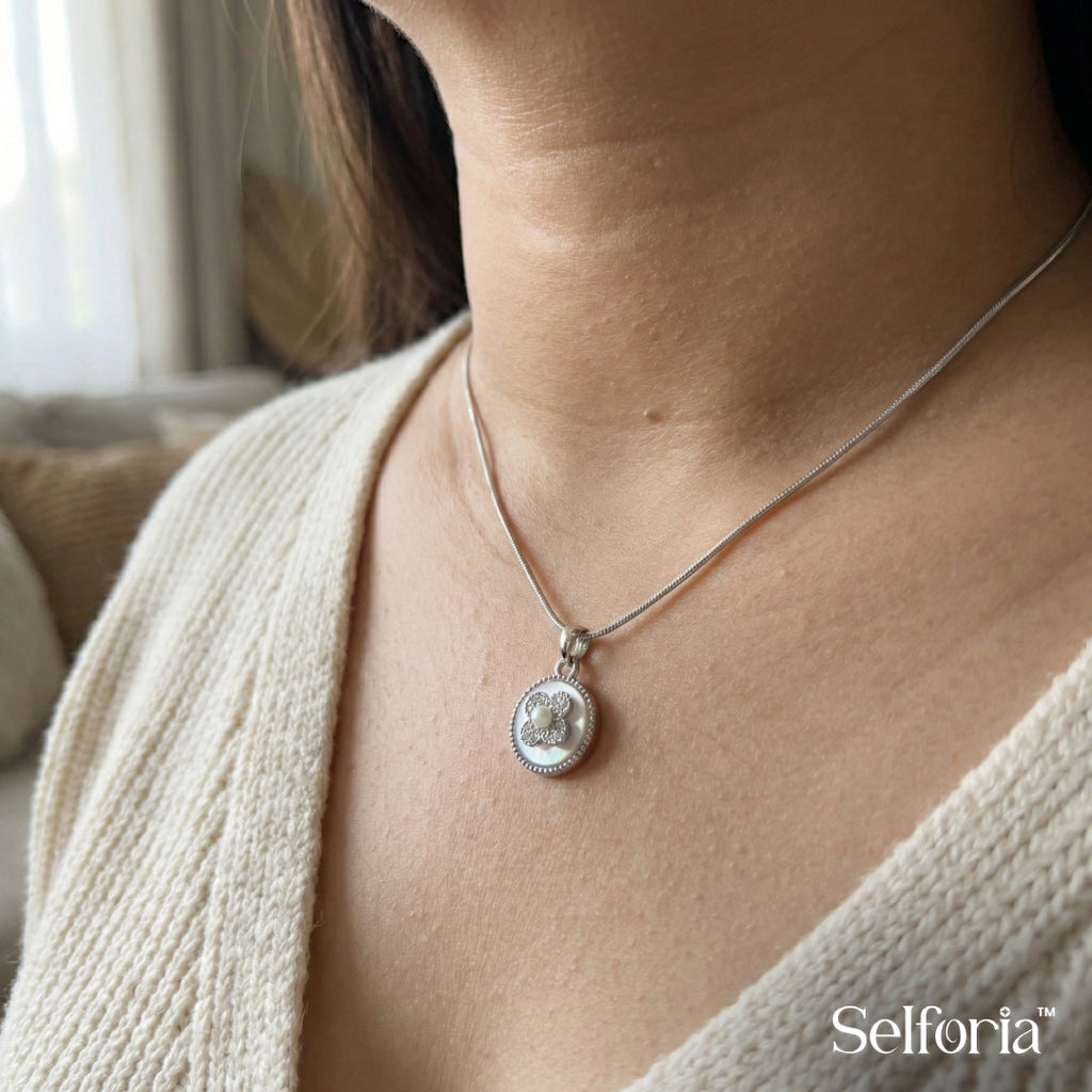 Woman wearing elegant silver floral pendant necklace with subtle sparkle, modern everyday jewellery