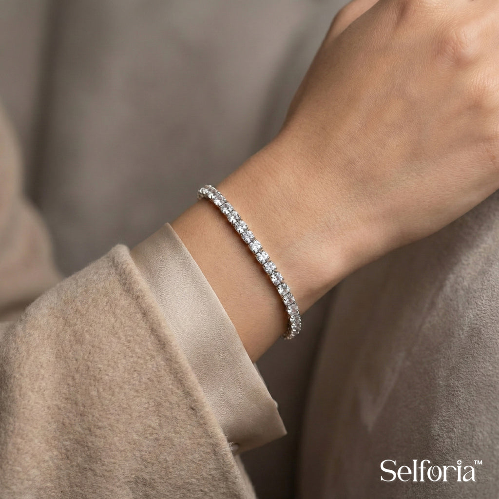 Close-up of silver tennis bracelet featuring sparkling stones and refined detailing