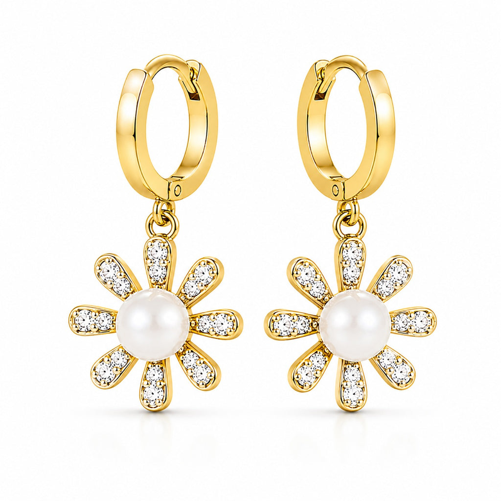 A pair of gold hoop earrings with dangling flower charms. Each flower charm features a central white pearl surrounded by clear pavé-set stones in a gold frame, shown on a clean white background.