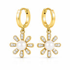 A pair of gold hoop earrings with dangling flower charms. Each flower charm features a central white pearl surrounded by clear pavé-set stones in a gold frame, shown on a clean white background.