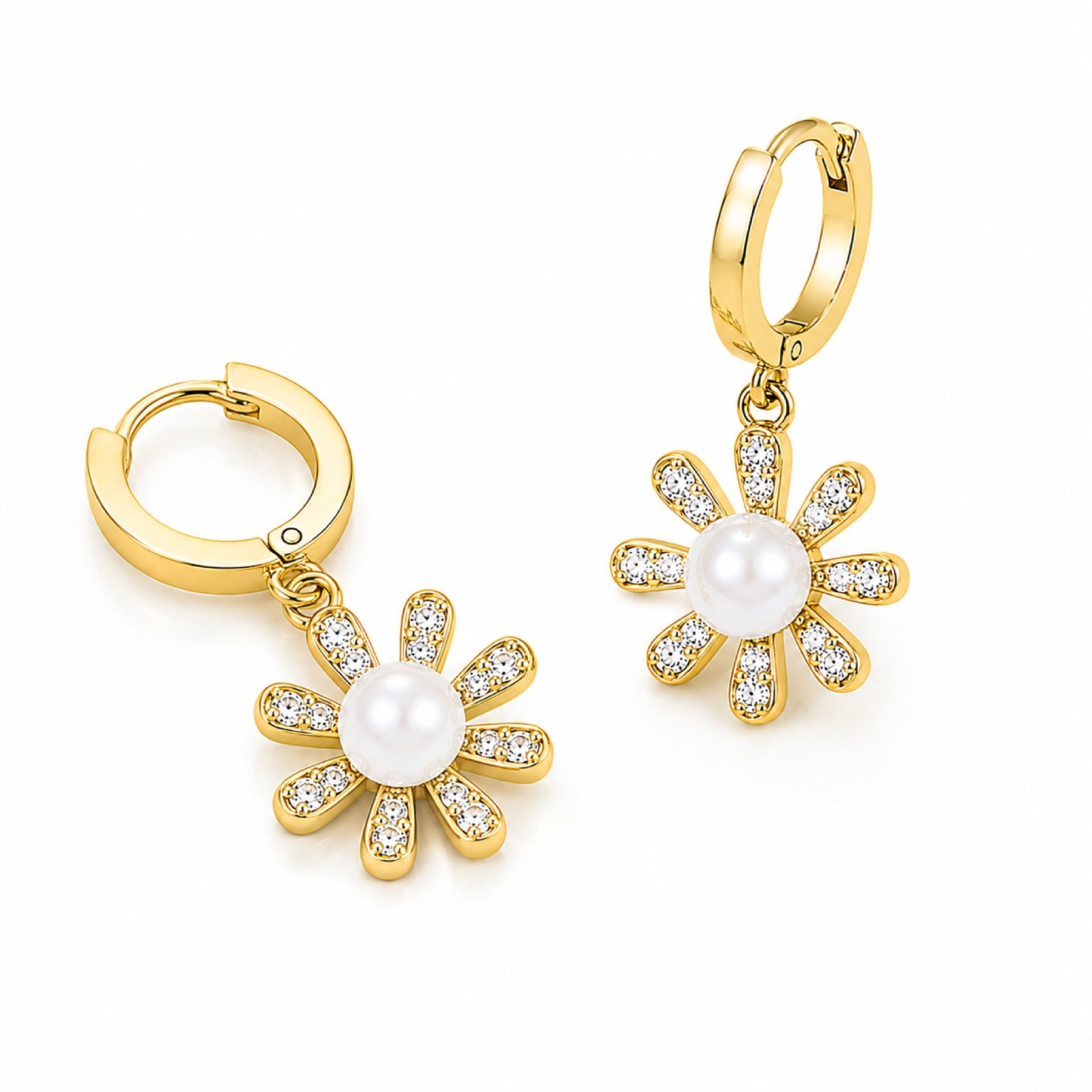 A pair of gold huggie hoop earrings with dangling flower charms. Each flower charm features a central white pearl surrounded by gold settings set with small clear crystals, shown on a clean white background.