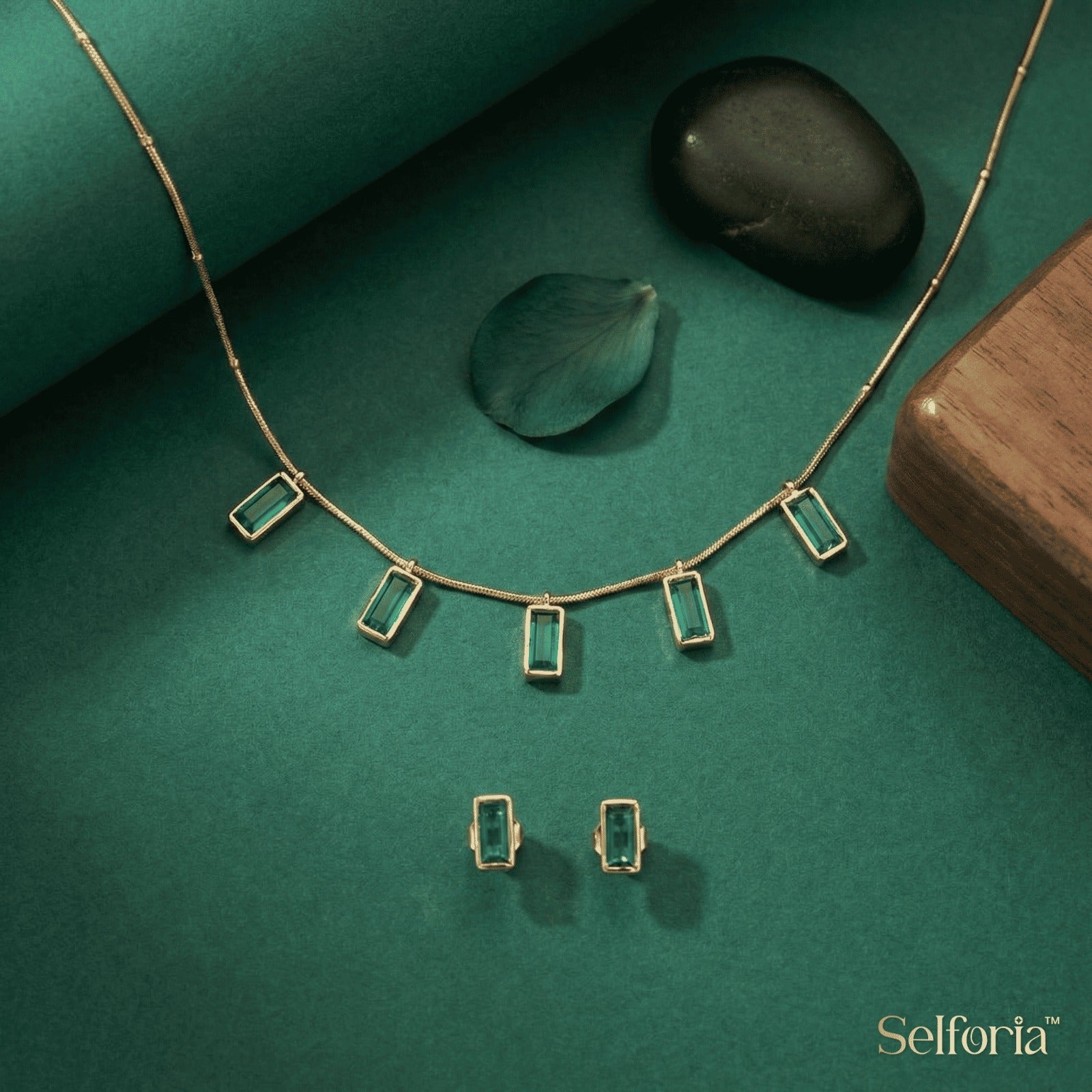 Minimal gold tone necklace with emerald green stone accents